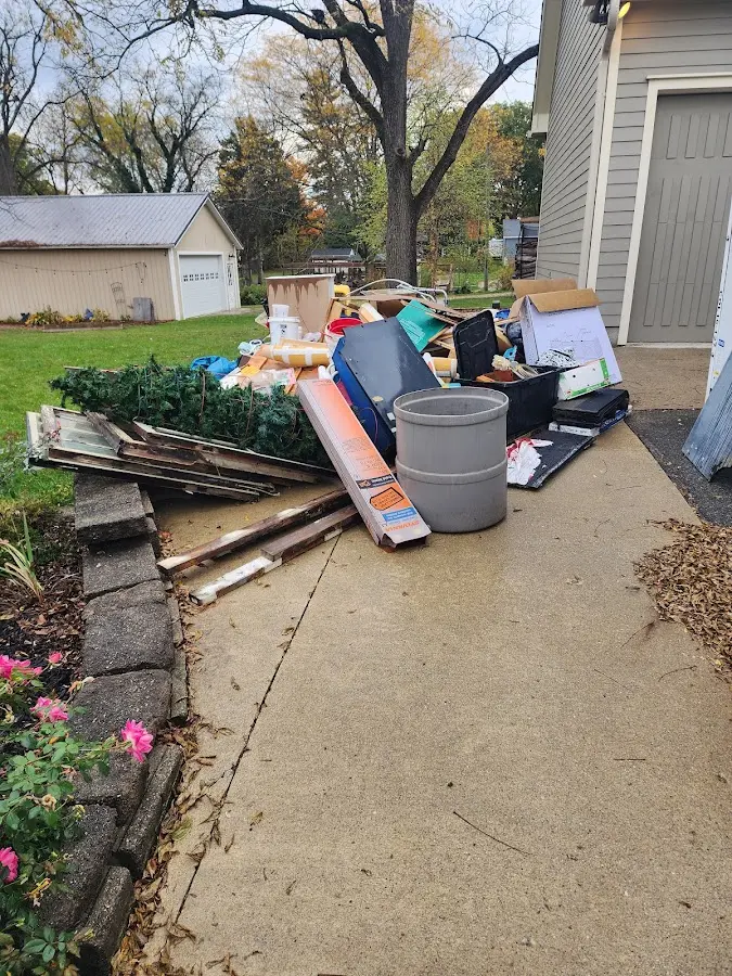 Dumpster being loaded with debris for Commercial Dumpster Rental in Gladstone